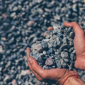 Crushed stones in the hands of a man. Selective focus. Nature.